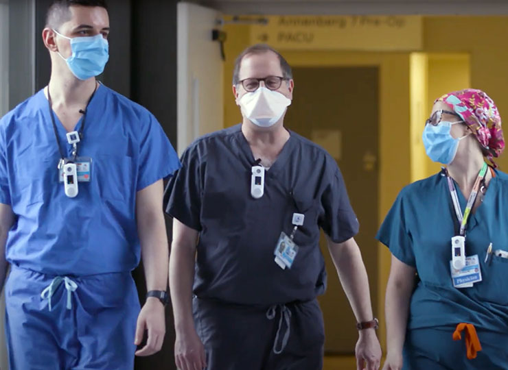 Image of three doctors walking down the hall