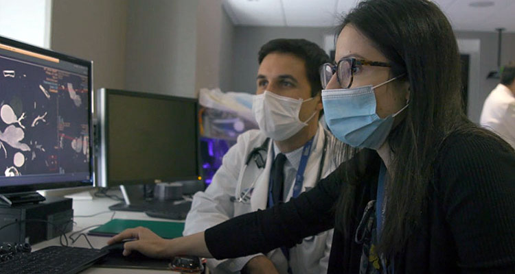 Image of doctors looking at computer screen