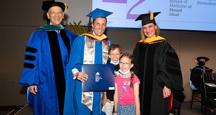 group shot of graduate with kids