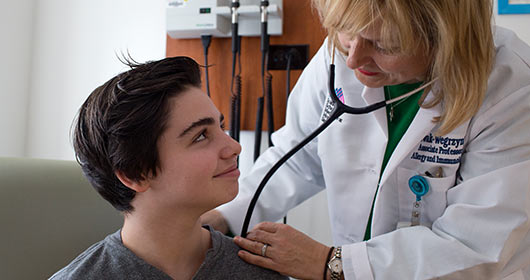Image of doctor examining teenage boy