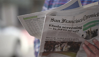 Image of person holding newspaper